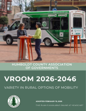 Cover page of VROOM. Two women standing at orange table on Gazebo Plaza in Eureka, with a Ride Humboldt cutaway van in the background